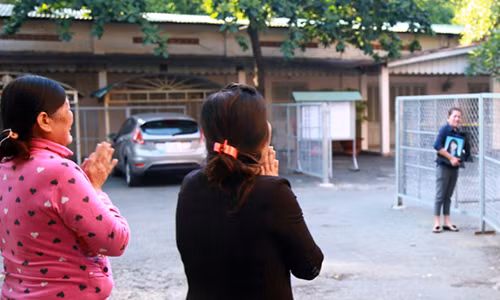 Mẹ Vũ Văn Tiến (bìa trái) vái lạy thân nhân nạn nhân vụ thảm sát ở Bình Phước tại địa điểm diễn ra phiên phúc thẩm. (Ảnh: VnExpress)