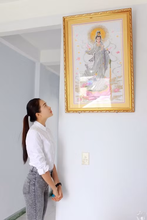 Bức tranh Phật bà do chính tay Lệ Hằng thêu được treo trang trọng trên tường.
