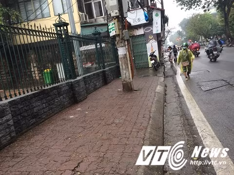 Cột điện, nhà dân thi nhau chiếm dụng vỉa hè của người đi bộ.