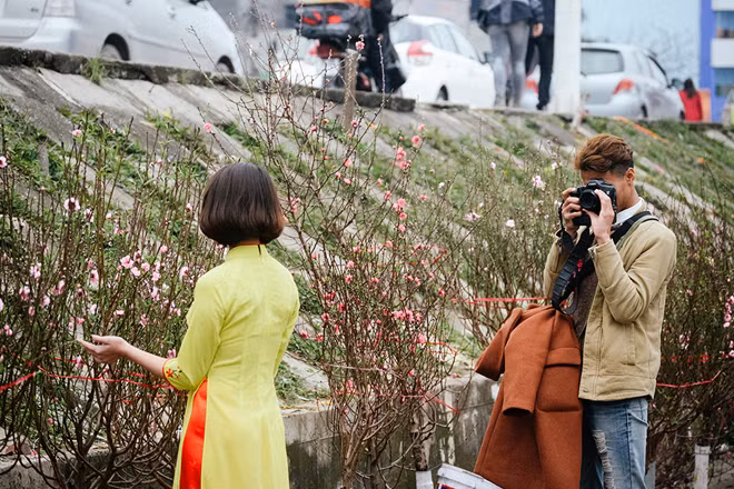 Nhiều bạn trẻ cũng tìm tới chợ hoa Quảng Bá để chụp lại bộ ảnh du xuân để chào đón một năm mới đang đến gần - Ảnh: Phan Quốc Bảo/ vnexpress.