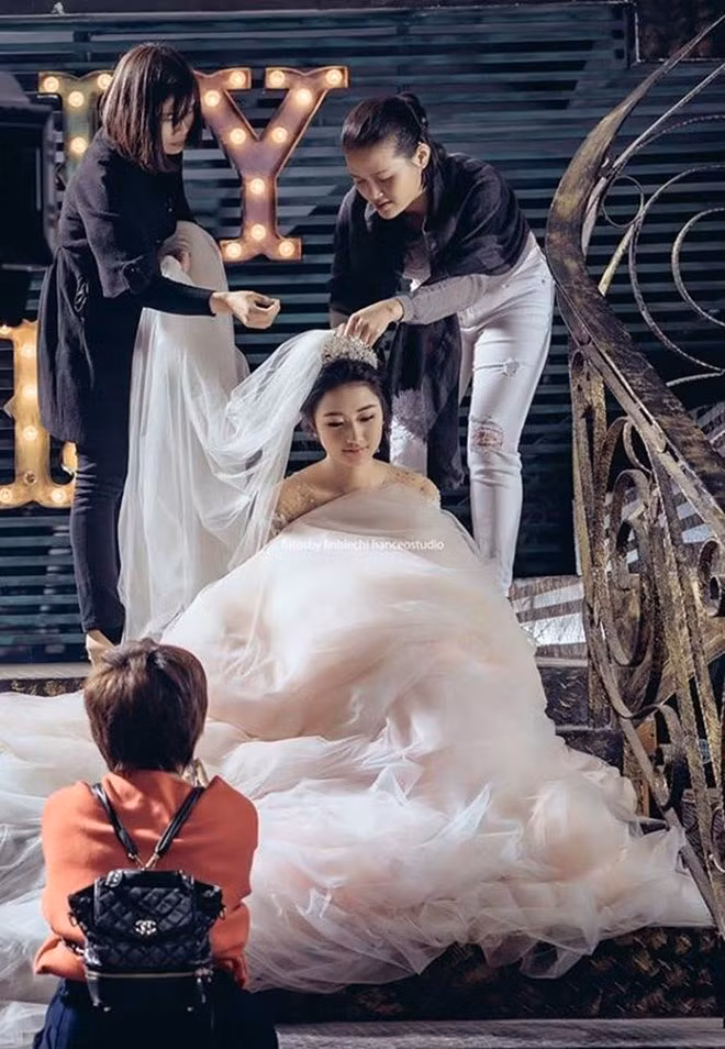 Khoảnh khắc trong hậu trường trước giờ hôn lễ của Thu Ngân. Người đẹp 20 tuổi đã có tiệc cưới ấm cúng bên người thân, bỏ qua lời dị nghị về khoảng cách tuổi tác với chú rể. "Sẽ đến một ngày bạn muốn vì một ai đó mà trở thành một người vợ hiền, người mẹ tốt, một người con dâu thảo, một người bạn thân nắm tay anh đến cuối cuộc đời", Thu Ngân trải lòng về việc kết hôn sớm. (Ảnh: Phương Linh)