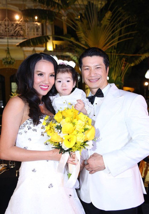 Cô con gái lớn của Dustin Nguyễn và Bebe Phạm may mắn được chụp ảnh cùng bố mẹ trong lễ cưới trong khi cô em gái quá nhỏ phải nhờ một người thân trong gia đình bế.