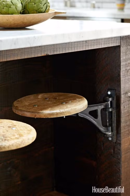  Ghế xoay: Nếu phòng bếp của bạn có diện tích rất hạn chế, bạn nên giản lược các loại đồ đạc, sử dụng các vật dụng có thể gấp gọn hoặc xếp khít vào nhau. Ví dụ như những chiếc ghế ăn, được thiết kế bắn trực tiếp vào bàn ăn, với bản lề có thể xoay ra xoay vào như một cánh cửa, không chỉ tiết kiệm diện tích mà còn giúp bàn ăn của bạn độc đáo có 1-0-2.