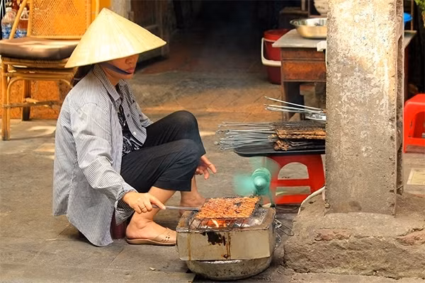 Người phụ nữ trong công đoạn chế biến bún chả, món ăn nổi tiếng tại Hà Nội.
