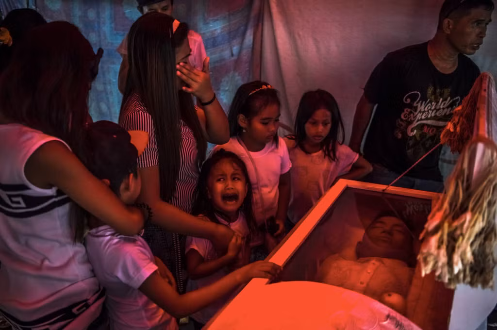 Cô bé Jimji, 6 tuổi, khóc bên quan tài của người cha Jimboy Bolasa, 25 tuổi.