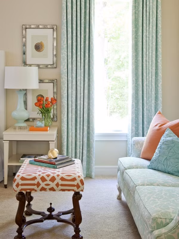 Phối màu giữa rèm cửa và đệm Trong những căn phòng nhiều ánh sáng, chắc chắn bạn không thể quên đi những chiếc rèm cửa. Rèm cửa màu xanh ngọc dễ tạo nên cảm giác về một bầu trời riêng êm dịu. Đi kèm với các phụ kiện màu cam như gối, bàn sẽ tạo nên một sự kết hợp thú vị.