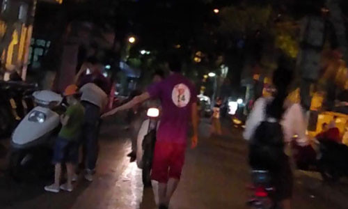 Những thanh niên này sẵn sàng lao ra giữa đường để vít xe máy, chặn đầu ô tô để mời chào khách vào ăn uống (Ảnh cắt từ clip)