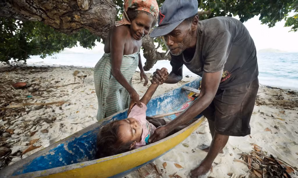 Do nguồn thức ăn và nước uống hiếm hoi nên người dân trên đảo Naghotano vẫn hàng ngày đi thuyền vào đất liền để làm việc trên các nông trại. Trẻ em vì thế cũng không đến trường mà thường đi cùng bố mẹ tới nơi làm việc. Bé gái này đã ngủ quên trên đường từ đất liền trở về sau một ngày làm việc.