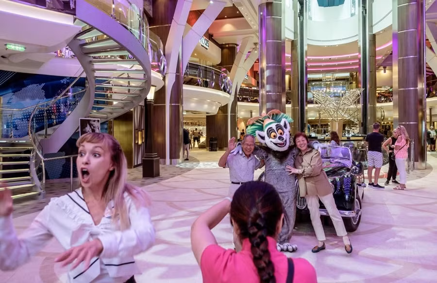 Hành khách chụp ảnh lưu niệm trong khu Royal Promenade. Đây chỉ là một trong 7 khu trên Harmony of The Seas. Tàu có 18 boong, 24 thang máy.