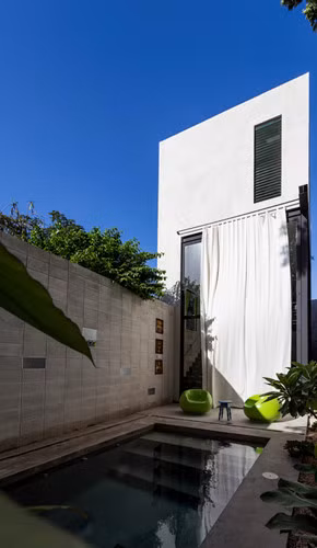 Một bức tường màu xanh lá cây ở phía Tây tăng cường các rào cản nhiệt, tránh nước quá nóng khu vực sân trung gian là các quá trình chuyển đổi từ việc tiếp cận khu vực sinh sống và đến sân bên trong của phòng ngủ.