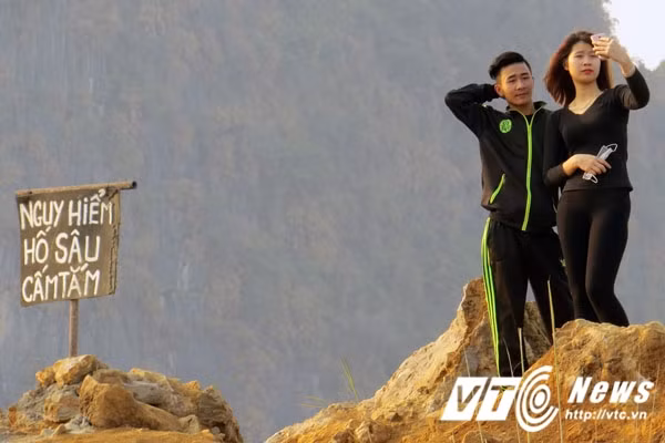 Nhiều bạn trẻ vẫn "làm ngơ" trước tấm biển cảnh báo nguy hiểm bên hồ.