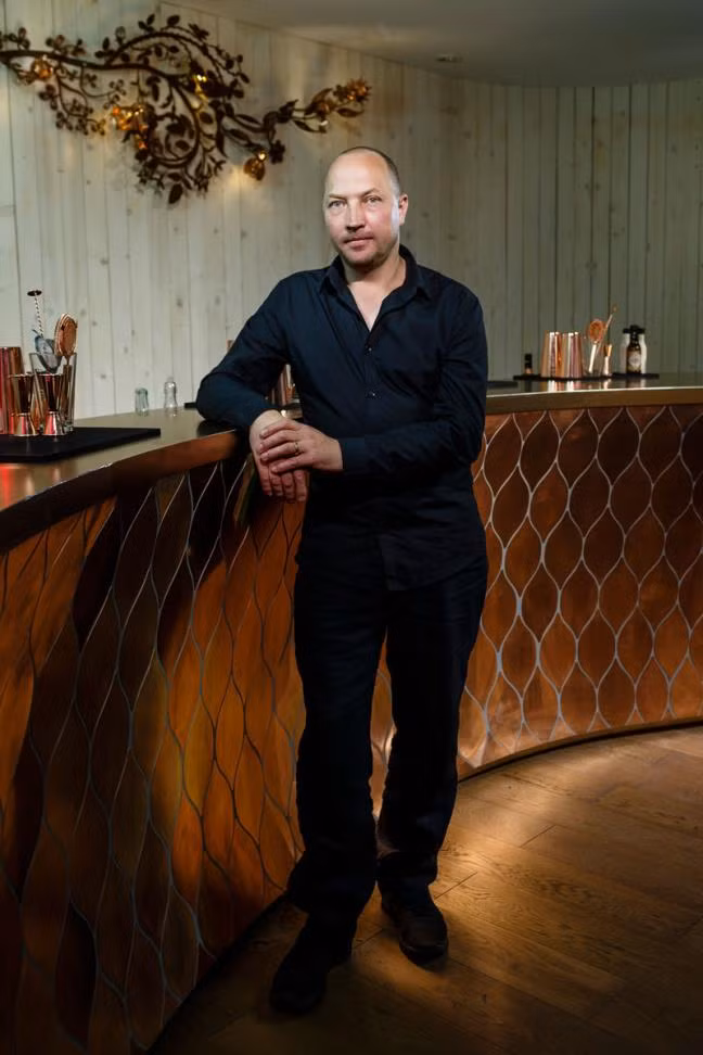 Trên nền quầy bar là màu nâu vàng đồng óng ánh, kiến trúc sư đã khôn khéo dùng công nghệ cẩn viền đồng đen bạc lên mặt đồng quầy bar theo các vảy viền hình lá cong lượn độc đáo.