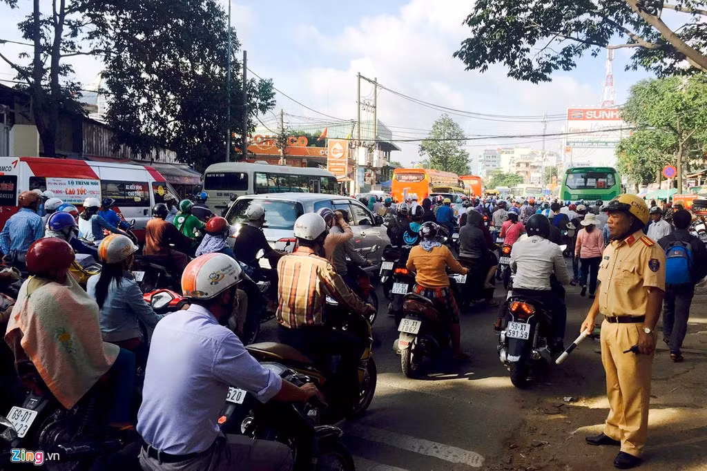 Giao thông khu vực trước Bến xe Miền Đông lưu thông cũng rất khó khăn. Tại đây, hai chiến sĩ CSGT cắm chốt phải hoạt động liên tục để điều tiết xe cộ.