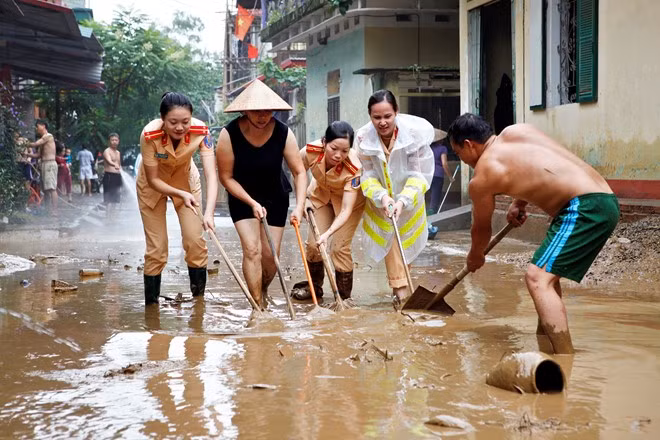 Bức ảnh Nữ chiến sĩ CSGT giúp người dân dọn bùn sau cơn lũ của tác giả Nguyễn Văn Miền (Yên Bái) nhận huy chương đồng thể loại ảnh đơn.