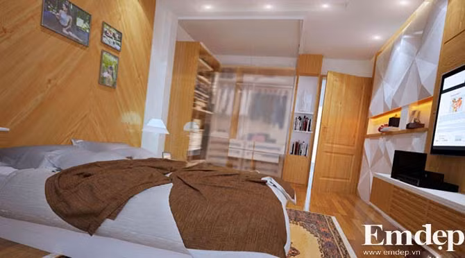 Phòng ngủ của vợ chồng gia chủ Không gian riêng của cặp đôi trẻ được chia thành hai ngăn cách bởi vách kính trong suốt. Một bên là giường ngủ, bàn trang điểm, tivi, một bên là tủ quần áo và kệ đồ trang trí. Sử dụng vật liệu gỗ chủ đạo KTS muốn mang đến cho không gian sự ấm áp, nhẹ nhàng và gần gũi.