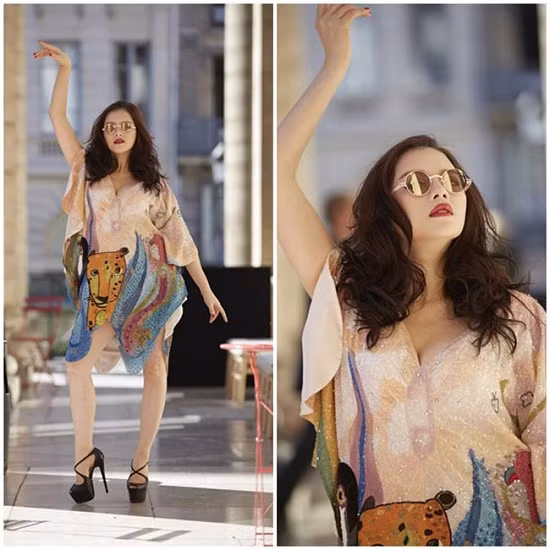 Lý Nhã Kỳ với cách tạo dáng khó hiểu giữa đất trời Paris. Nó khiến cho bộ đầm hàng hiệu của cô mất hẳn giá trị.