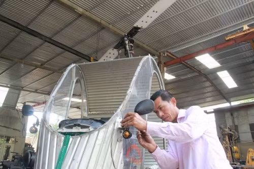 Chủ nhân của chiếc trực thăng mô hình đang hoàn chỉnh các chi tiết cuối cùng cho sản phẩm của mình.