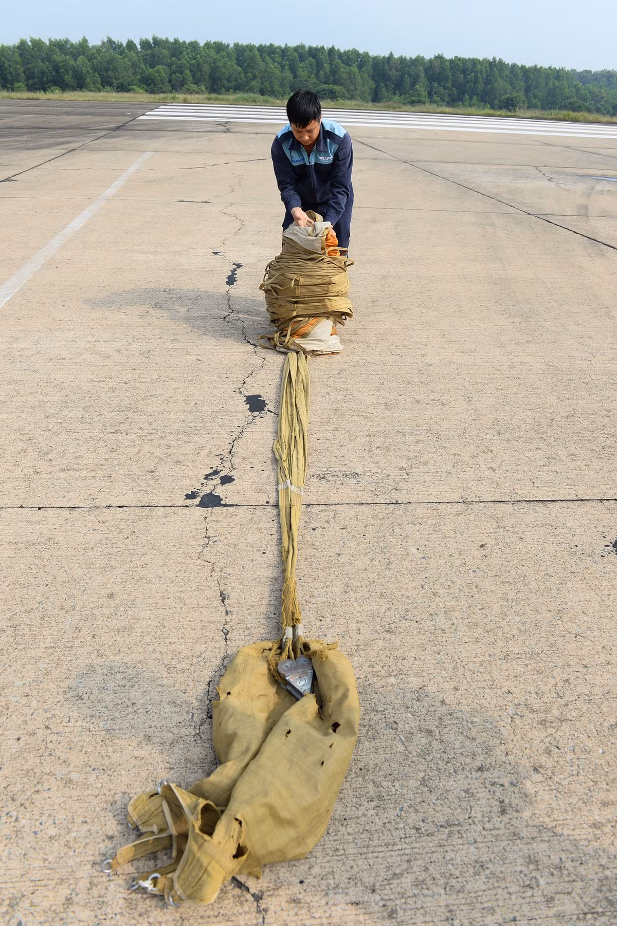 Lính không quân xếp dù lại sau khi máy bay ngắt dù giảm tốc.