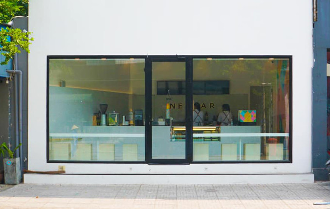 Quán mang phong cách tối giản, bảng hiệu cũng rất đơn giản và gọn gàng, chỉ chứa được 10 khách, phục vụ đồ ăn lành mạnh như salad, sandwich và nước ép.