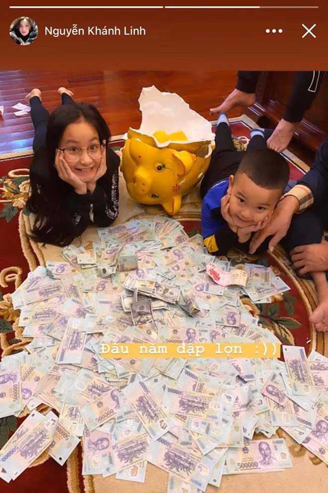 Khi dân tình còn chưa hết trầm trồ với pha mừng tuổi hoành tráng đó thì một lần nữa, bà xã của Tiến Dũng lại công khai hình ảnh đập lợn vàng đầu năm với những xấp tiền 500 nghìn, 100 USD mới cứng. Ảnh: FBNV.