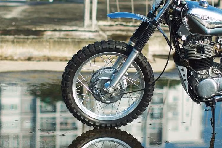 Theo biker này cho biết, 60% chiếc xe là các chi tiết chế tạo thủ công. Ở phía trước, chiếc xe được anh giữ lại bộ phanh đùm đặc trưng của SR400, tuy nhiên đan vào vành nhôm Excel 1,85 x 19 inch, đi kèm lốp gai Continental TKC80 với kích thước 100/90/19. Giảm xóc trước với hành trình lớn đã được lấy từ Honda XL250R.