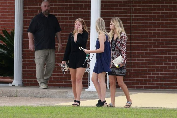 Hình ảnh một phụ nữ trẻ xúc động lau nước mắt sau khi dự lễ tang của một nạn nhân khác trong vụ xả súng ở Santa Fe, tên là Aaron Kyle McCleod.