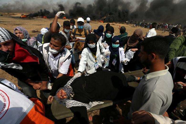 Người phụ nữ bị thương được đưa ra khỏi khu vực xảy ra đụng độ trên biên giới Gaza-Israel.