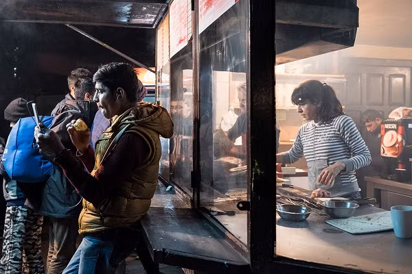 Người tị nạn mua đồ ăn tại một công viên gần nhà ga Belgrade.