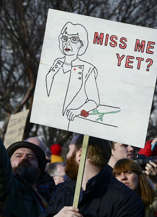 Một người biểu tình giơ cao tấm biển có hình ảnh cựu Thủ tướng Iceland Jóhanna Sigurðardóttir, người đã rời nhiệm sở năm 2013.