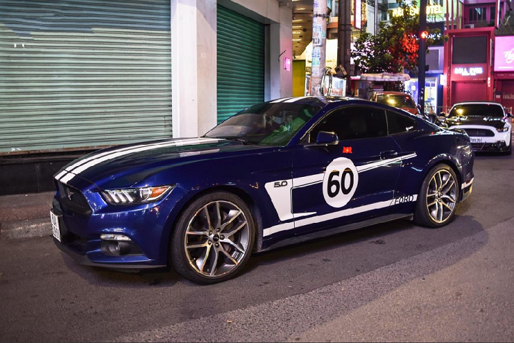 Lần họp mặt này còn có sự xuất hiện của chiếc Mustang GT hiếm hoi được trang bị động cơ V8 5.0 lit. Tại Việt Nam, đa số những chiếc Mustang đều thuộc phiên bản EcoBoost với dung tích chỉ 2.3 lit. Kết hợp với màu áo xanh của chiếc xe chính là lớp decal màu trắng bắt mắt. Ta có thể dễ dàng nhận thấy lớp decal này được lấy cảm hứng từ Heritage Edition – Một màu đã vốn quen thuộc trên nhiều mẫu xe thể thao của Ford.