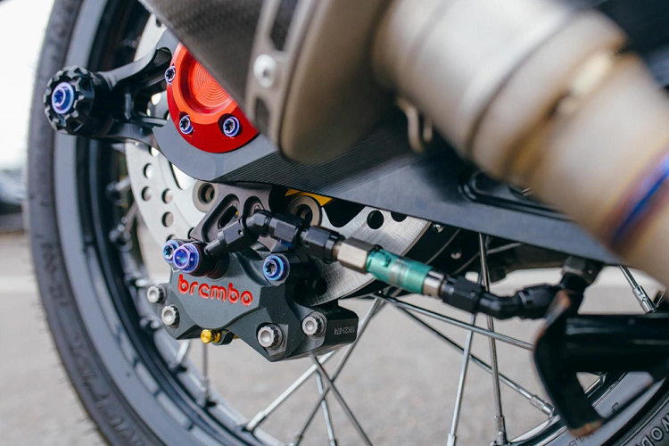 Dàn chân phía sau cũng được nâng cấp không kém phía trước. Bộ gắp nguyên bản được thay bằng bộ gắp CNC, đi kèm là giảm xóc Ohlins TTX. Hệ thống phanh sử dụng đĩa phanh Brembo Moto3 kết hợp kẹp phanh Brembo GP.