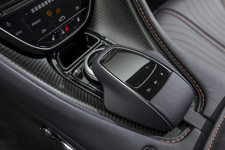 Aston Martin DB11 được loại bỏ cần số truyền thống, thay vào đó là bộ chuyển số được thiết kế dạng nút bấm đặt bên dưới màn hình giải trí. Lẫy chuyển số và các chế độ lái được đặt trên vô-lăng.