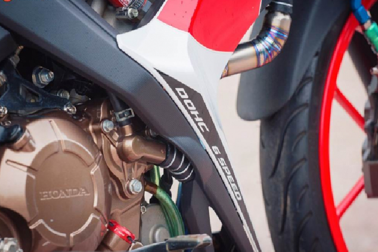 Nhấn nhá nhẹ nhàng cho phần lốc máy vàng đồng bằng một chú ốc nhớt Rizoma chính hãng do Ý sản xuất. Chi tiết cuối cùng là phuộc Nitron bình dầu rời, một sản phẩm đến từ Anh Quốc nổi tiếng với tông màu xanh riêng biệt khó nhằm lẫn với những sản phẩm khác, đem lại khả năng đàn hồi nhẹ nhàng và êm ái, chống sàng lắc khi vào cua ở tốc độ cao.