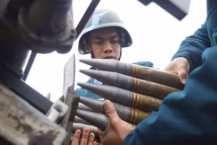 Pháo thủ số 5 và số 6 thao tác nạp đạn cho pháo phòng không 37mm.