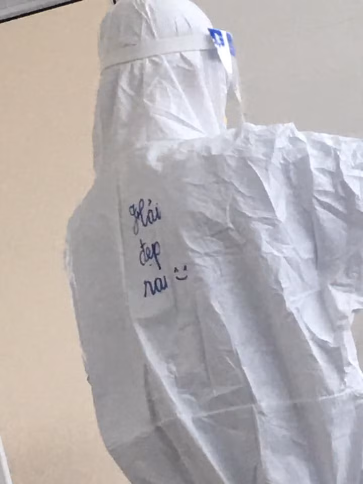 Mặc dù khoác lên mình lớp áo bảo hộ nóng nực nhưng dường như không che giấu được sự đáng yêu, tinh thần lạc quan của những "chiến sĩ áo trắng".