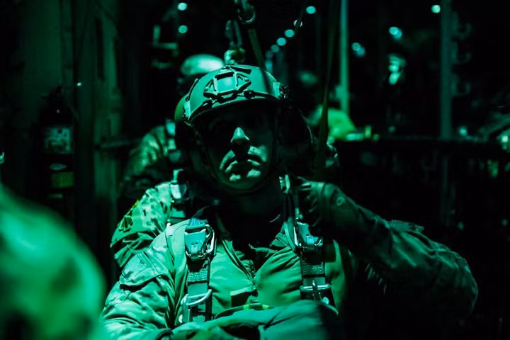 Lính đặc nhiệm mũ nồi xanh chuẩn bị thoát khỏi máy bay C-130 Hercules trong một cuộc nhảy dù đêm ở Colorado, Mỹ.