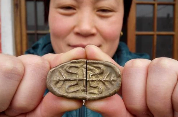 Tuy nhiên, cô Trương thấy viên đá bị chẻ đôi đang phát ra ánh sáng lấp lánh. Cô vội gạt đống đất bám bên trên và nhận ra rằng vật cô đào được không hề tầm thường.