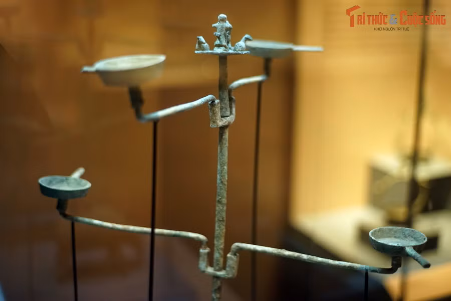 Trên thân đèn có hai giá đỡ, mỗi giá có hai đĩa đèn. Bốn đĩa đèn của cây đèn quay về bốn hướng khác nhau.