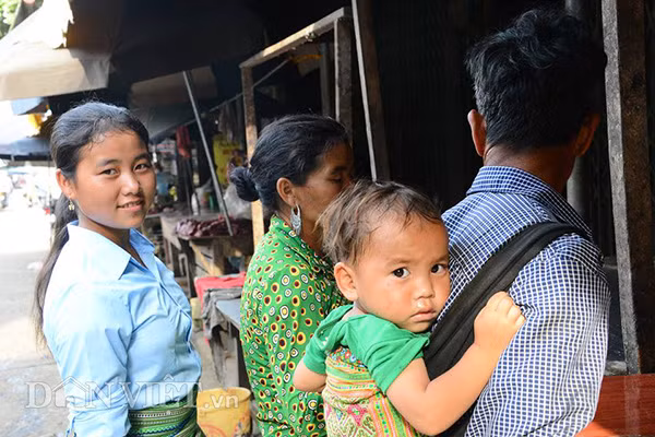 Em bé người Mông theo bố mẹ xuống chợ.