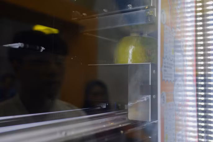 Không còn cảnh phải dùng dao để chặt dừa, những trái dừa sẽ được di chuyển lên phía trên và sẽ được "chặt" tự động ngay trên máy.