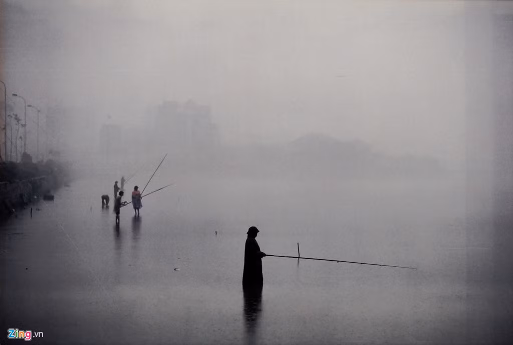 Nhiều người không quản ngại rét mướt lội nước câu cá trên hồ. 