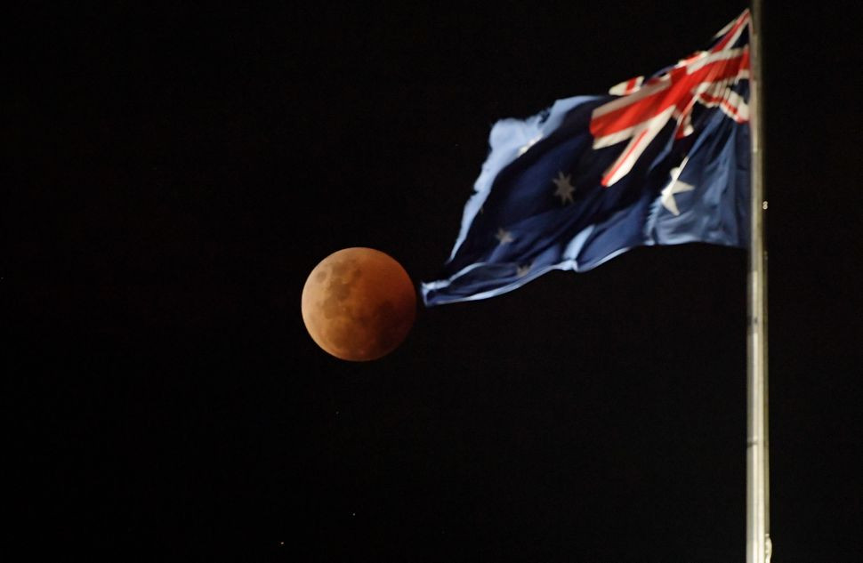 Nhiếp ảnh gia chụp được ảnh Trăng máu - hiện tượng thiên văn tuyệt đẹp ở phía trên tòa nhà Quốc hội ở Canberra, Australia. Ảnh: Tracey Nearmy via Getty Images.