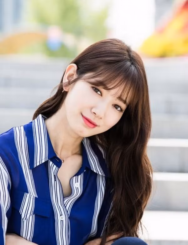 Kiểu tóc xoăn nhẹ nhàng, mái thưa giúp cho gương mặt mỹ nhân xứ Hàn thêm dịu dàng, nữ tính và dễ thương.