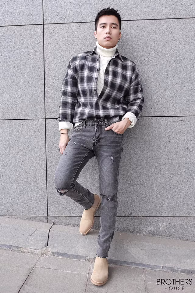 Áo len cổ lọ phối với sơ mi kẻ và quần jean rách gối cực ngầu.