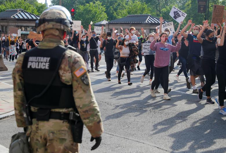 Thành viên của Vệ binh Quốc gia đứng nhìn nhóm người biểu tình tuần hành ở Boston, bang Massachusetts, ngày 3/6.