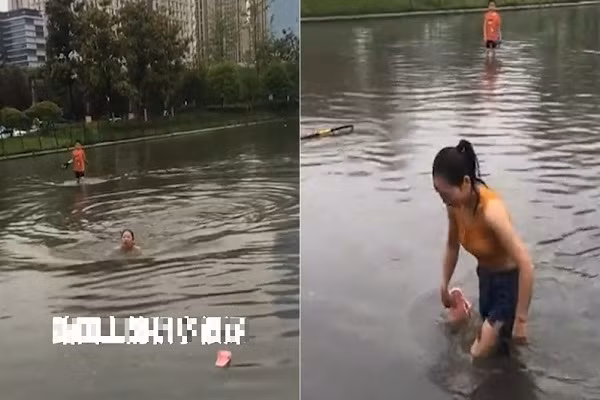 Video: Co gai boi qua con duong ngap nuoc vi so di lam muon