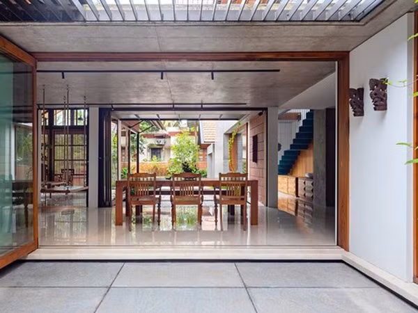 Một chiếc cửa bằng kính có thể gấp lại, mở ra không gian rộng cho căn nhà.