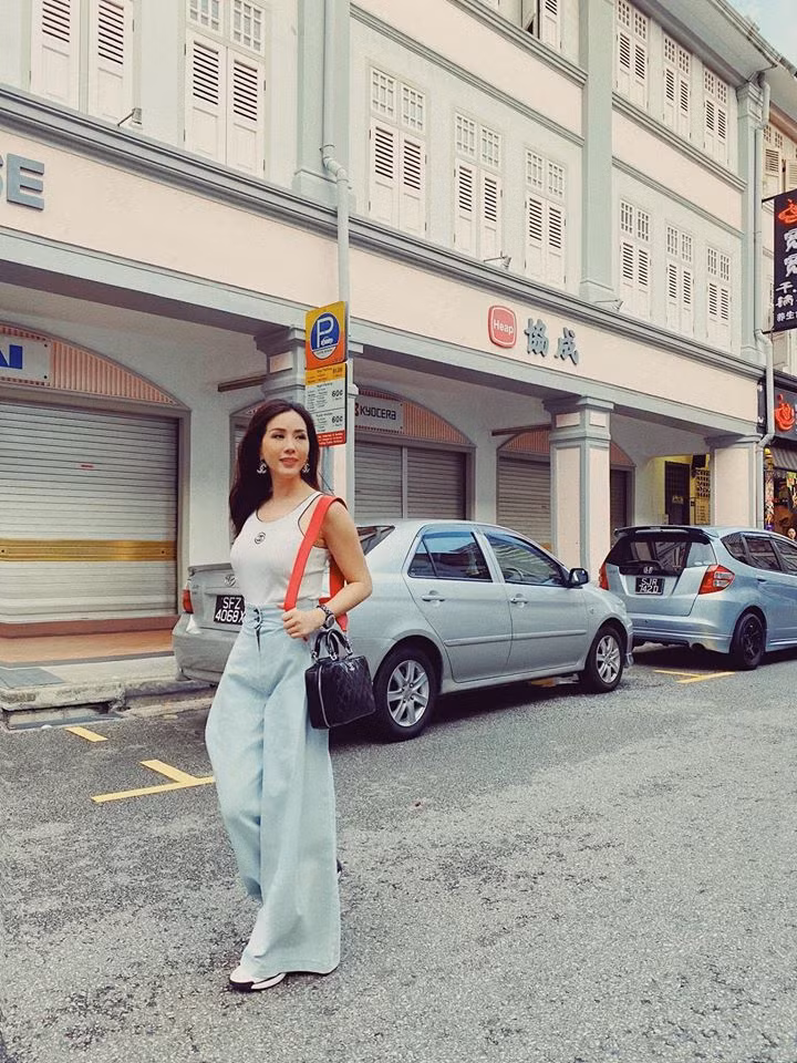 Khi xuống phố, cô chọn áo thun sát nách và quần ống rộng trẻ trung.