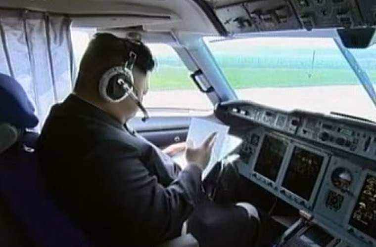 Ông Kim Jong-un ngồi đọc các tài liệu hướng dẫn bay trong buồng lái trước giờ cất cánh.