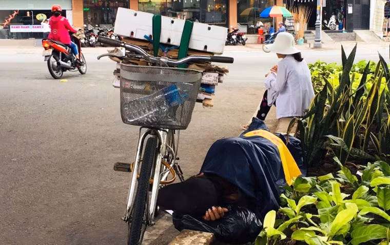 Thời tiết ở TP HCM suốt 2 ngày đầu năm xuống thấp, có lúc chỉ còn 22 độ C khiến những người nghèo mưu sinh trên đường khốn đốn.